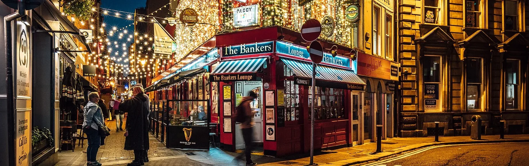 The Bankers Bar lit up on Trinity Street at night