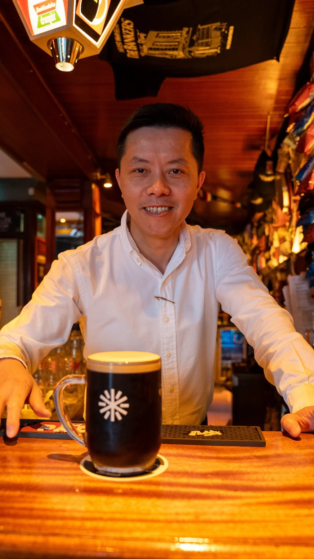 The Bankers staff member welcoming guests with a freshly poured drink
